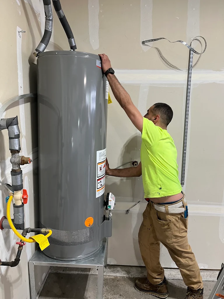 Elite Plumbing technician installing a new water heater