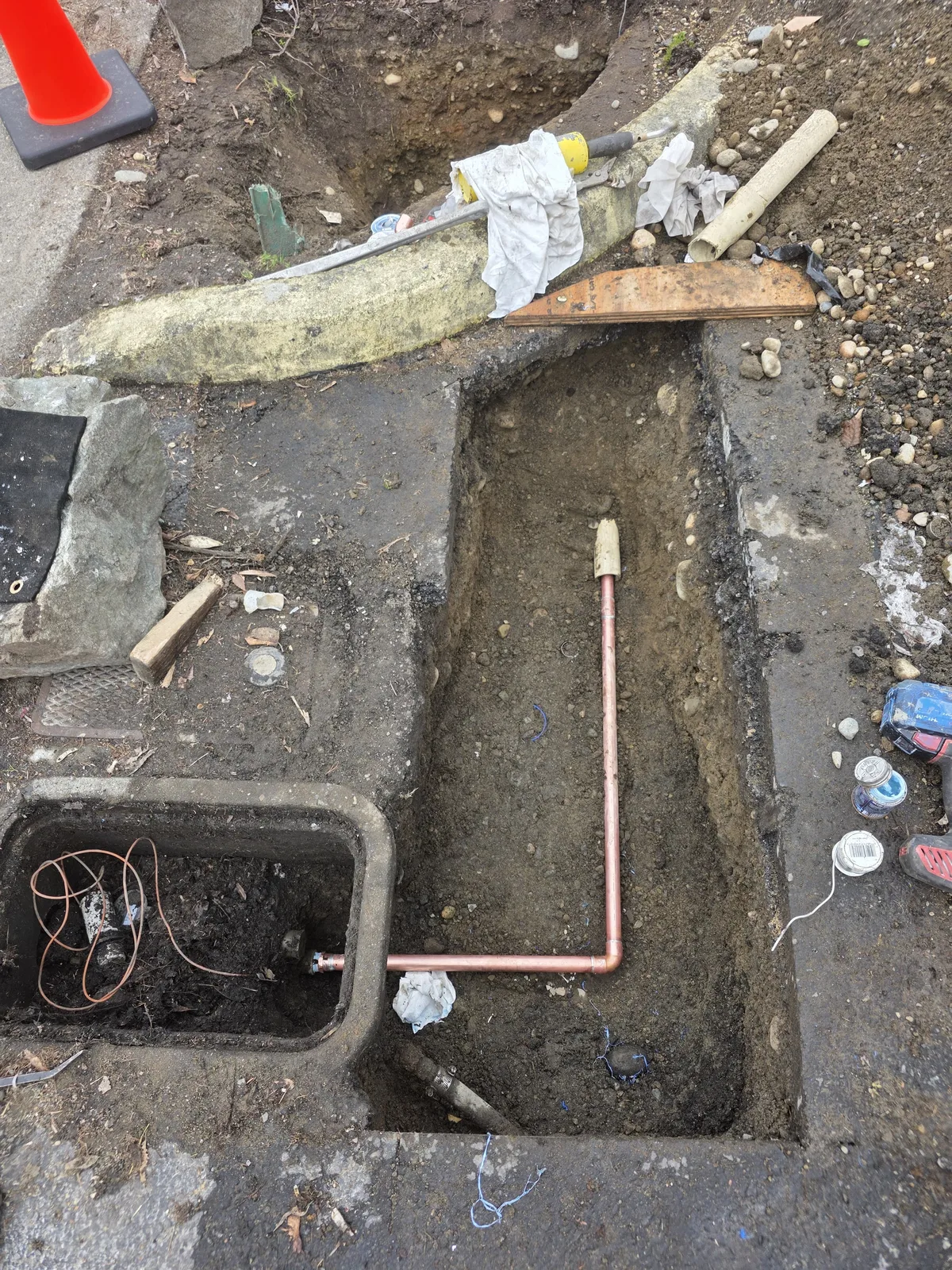 New copper water service line in an open trench at the meter