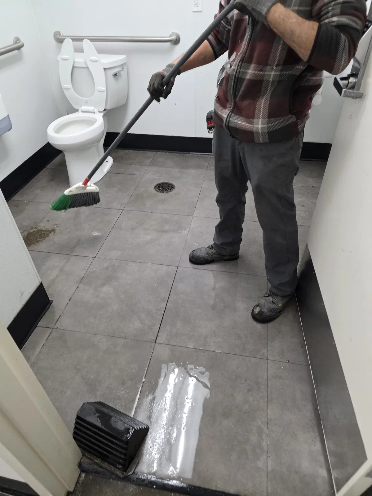Technician cleaning the floor after a job